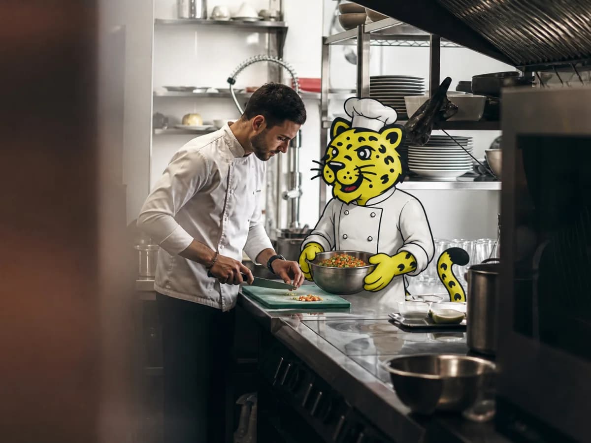 Chef chopping ingredients while Leo holds a mixing bowl