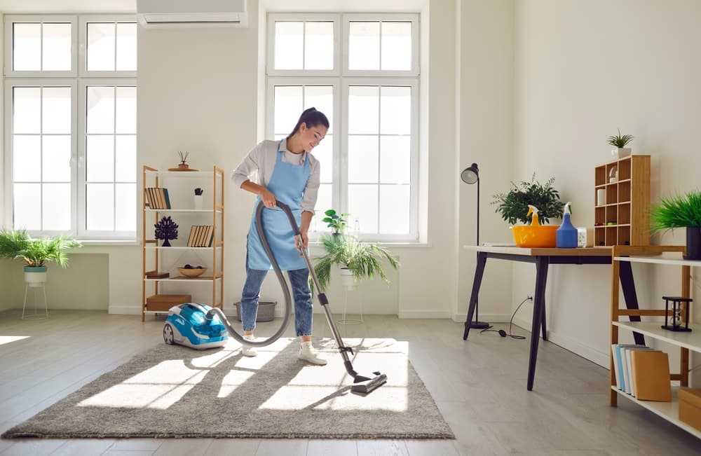 Service worker cleaning a bright customer space